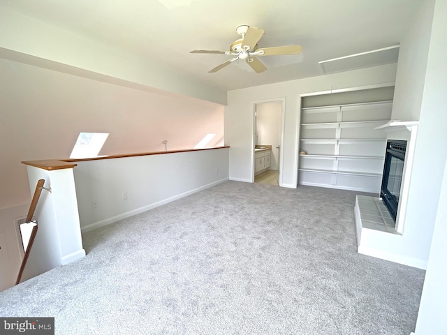 957 Terrapin St Unit 2, Bethany Beach, DE 19930 - unfurnished living room featuring attic access, a ceiling fan, carpet floors, a glass covered fireplace, and baseboards