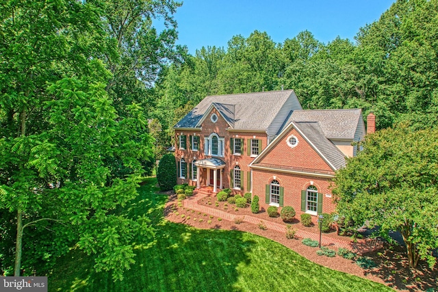 1296 Newkirk Ct, Vienna, VA 22182 - colonial house with brick siding, a front lawn, and roof with shingles