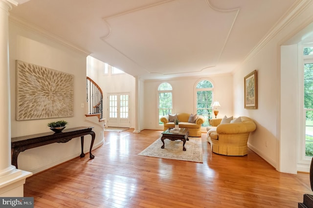 1296 Newkirk Ct, Vienna, VA 22182 - living room featuring decorative columns, stairway, light wood finished floors, and ornamental molding