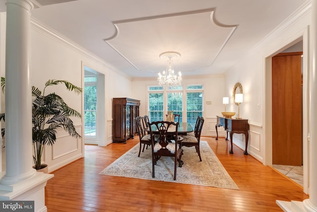 1296 Newkirk Ct, Vienna, VA 22182 - dining space featuring ornate columns, light wood-style floors, a chandelier, a decorative wall, and healthy amount of natural light