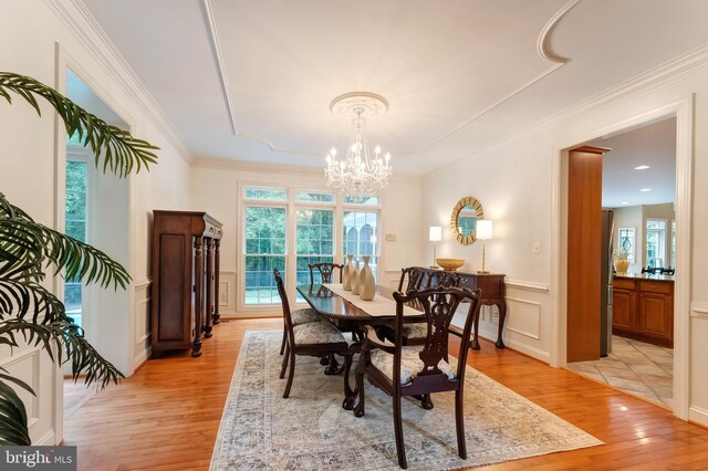 1296 Newkirk Ct, Vienna, VA 22182 - dining room featuring light wood-type flooring, healthy amount of natural light, a chandelier, a decorative wall, and wainscoting