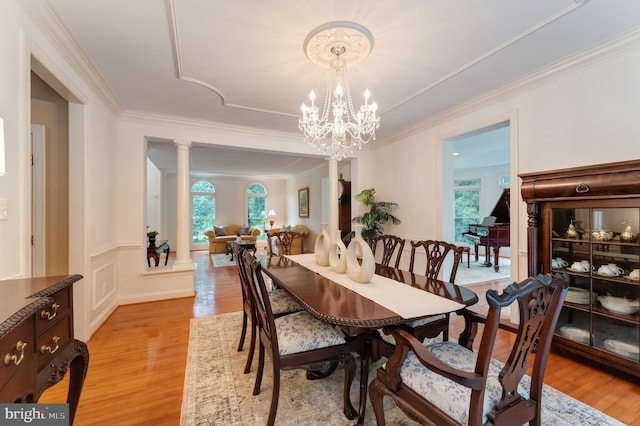 1296 Newkirk Ct, Vienna, VA 22182 - dining room with ornate columns, light wood-style flooring, ornamental molding, and a chandelier