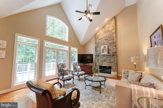 1296 Newkirk Ct, Vienna, VA 22182 - living room with light wood-style floors, high vaulted ceiling, a stone fireplace, and a ceiling fan