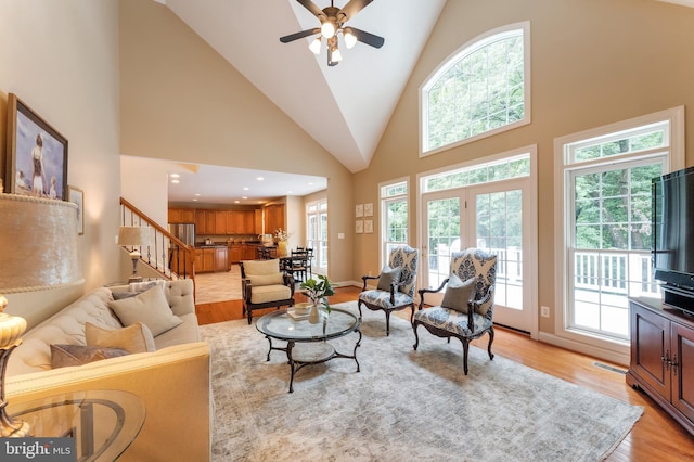 1296 Newkirk Ct, Vienna, VA 22182 - living area with light wood finished floors, stairway, high vaulted ceiling, and a ceiling fan