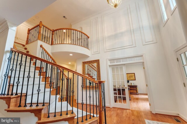 1296 Newkirk Ct, Vienna, VA 22182 - staircase featuring a high ceiling, wood finished floors, and french doors