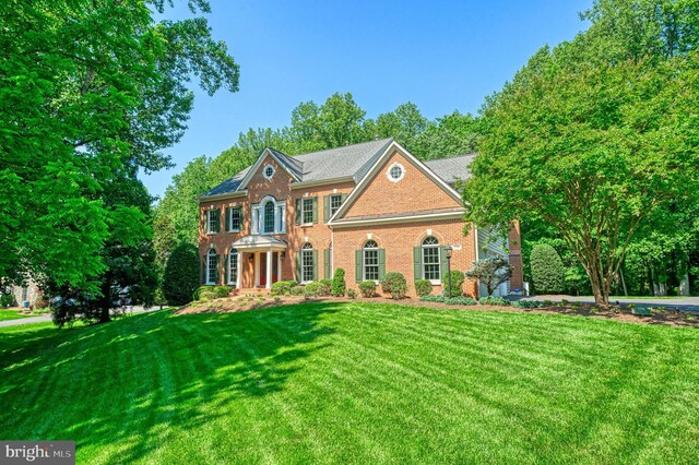 1296 Newkirk Ct, Vienna, VA 22182 - georgian-style home with a front yard and brick siding