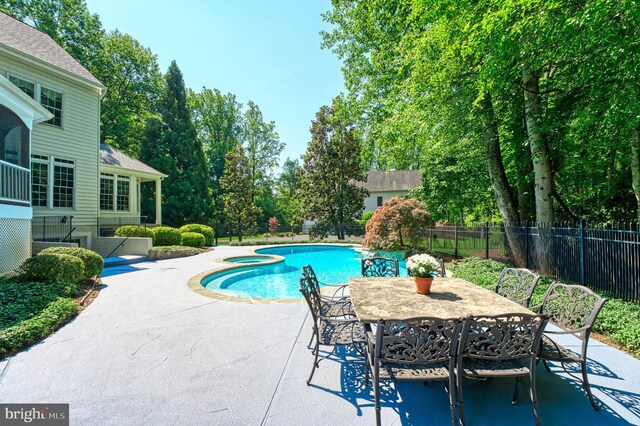 1296 Newkirk Ct, Vienna, VA 22182 - view of pool with a patio area, a pool with connected hot tub, outdoor dining space, and view of scattered trees