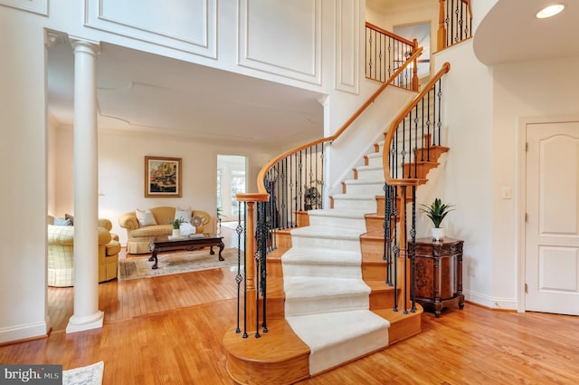 1296 Newkirk Ct, Vienna, VA 22182 - stairway featuring ornate columns, wood finished floors, and ornamental molding