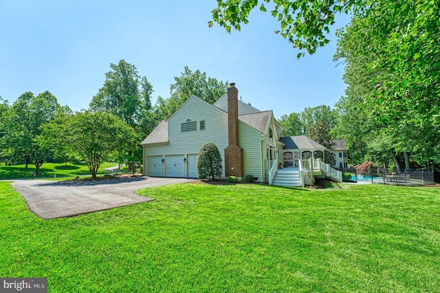1296 Newkirk Ct, Vienna, VA 22182 - view of property exterior featuring driveway, a chimney, an attached garage, a deck, and an outdoor pool