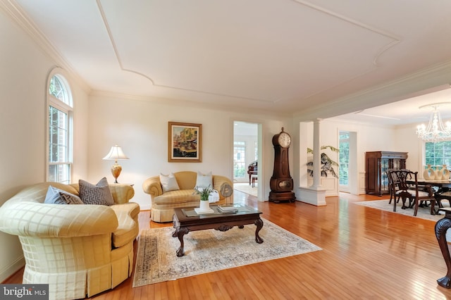 1296 Newkirk Ct, Vienna, VA 22182 - living room featuring hardwood / wood-style floors, a chandelier, crown molding, and ornate columns