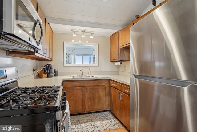 398 Kingfisher Rd, Tuckerton, NJ 08087 - kitchen featuring stainless steel appliances, a sink, brown cabinetry, and light countertops