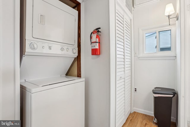 398 Kingfisher Rd, Tuckerton, NJ 08087 - washroom with estacked washer and dryer, light wood finished floors, and baseboards