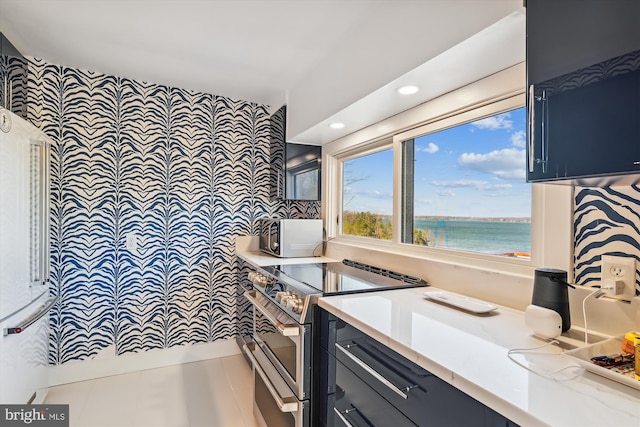 201 Nottingham Hl, Annapolis, MD 21405 - kitchen with range with two ovens, a water view, recessed lighting, blue cabinetry, and light stone counters