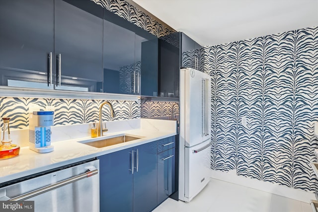 201 Nottingham Hl, Annapolis, MD 21405 - kitchen featuring dishwasher, a sink, freestanding refrigerator, blue cabinets, and light stone countertops