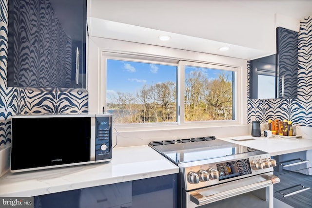 201 Nottingham Hl, Annapolis, MD 21405 - kitchen featuring stainless steel range with electric stovetop, light stone countertops, blue cabinetry, and recessed lighting