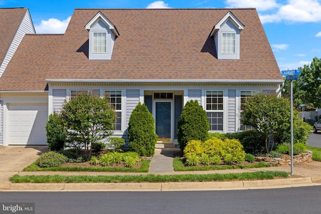 cape cod house featuring an attached garage, concrete driveway, a shingled roof, and entry steps