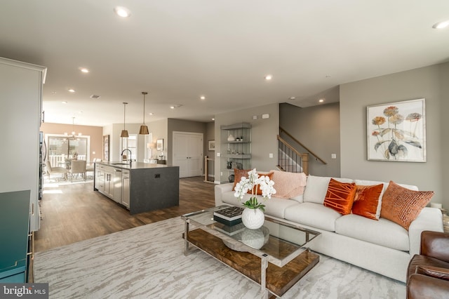 living room featuring dark wood-style floors, recessed lighting, a chandelier, and stairway