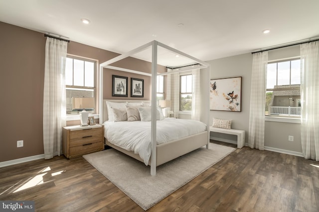 bedroom featuring multiple windows, baseboards, dark wood-type flooring, and recessed lighting