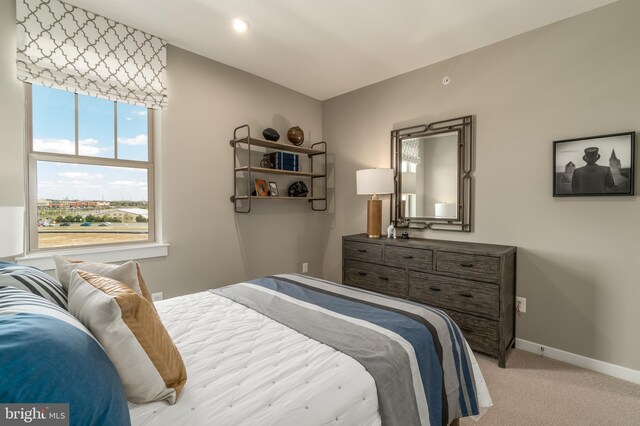 bedroom featuring light carpet, baseboards, and recessed lighting