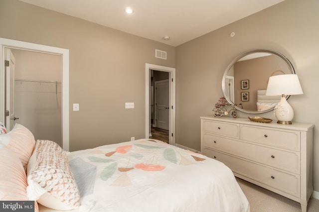bedroom with a spacious closet, a closet, and baseboards