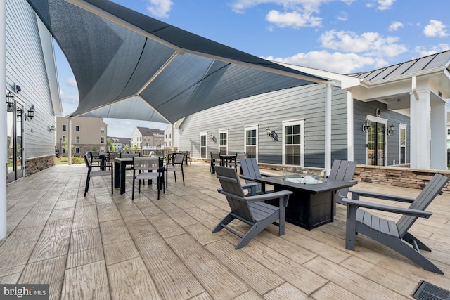 view of patio / terrace featuring outdoor dining space and a fire pit