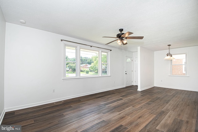 126 Clymer Ave, Front Royal, VA 22630 - empty room with dark wood-style flooring, a ceiling fan, healthy amount of natural light, baseboards, and a textured ceiling