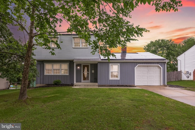 12 Constitution Rd, Clementon, NJ 08021 - view of front of property with board and batten siding, a chimney, an attached garage, concrete driveway, and roof mounted solar panels