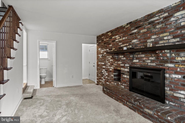 12 Constitution Rd, Clementon, NJ 08021 - unfurnished living room with stairs, carpet floors, a brick fireplace, and baseboards