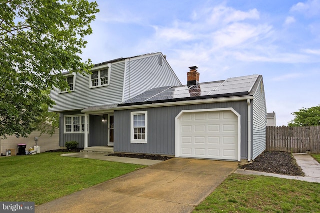 12 Constitution Rd, Clementon, NJ 08021 - view of front of home with a chimney, roof mounted solar panels, an attached garage, concrete driveway, and board and batten siding