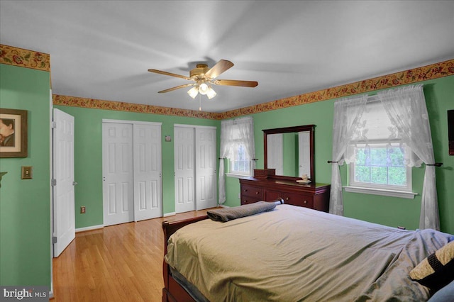3919 Penns Dr, Reading, PA 19606 - bedroom featuring two closets, light wood-style flooring, baseboards, and ceiling fan