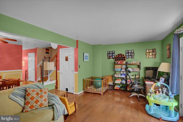 3919 Penns Dr, Reading, PA 19606 - living room featuring wood finished floors, a ceiling fan, and stairway