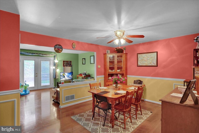 3919 Penns Dr, Reading, PA 19606 - dining area with french doors, wainscoting, wood finished floors, and a ceiling fan