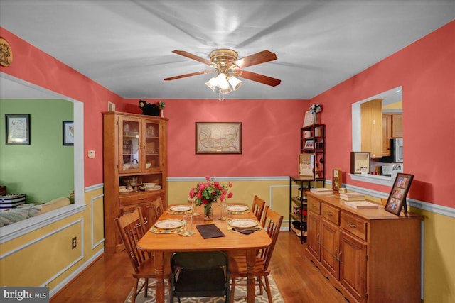 3919 Penns Dr, Reading, PA 19606 - dining area featuring ceiling fan, light wood-style flooring, and wainscoting