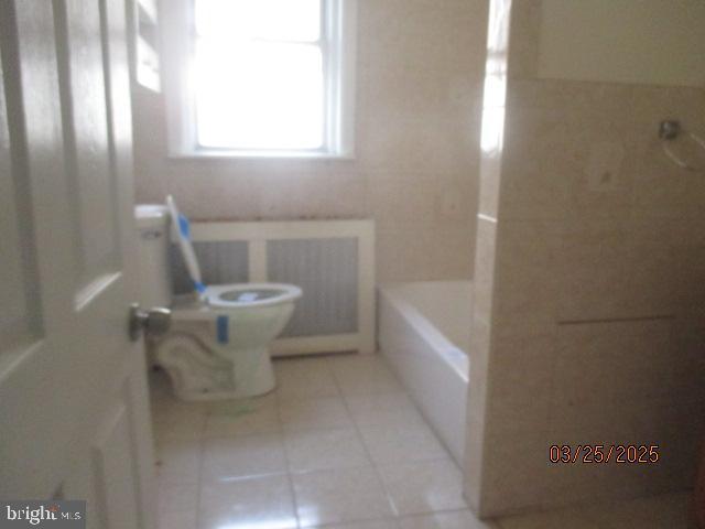 5322 N Carlisle St, Philadelphia, PA 19141 - bathroom featuring toilet, tile patterned floors, a bath, a shower, and radiator