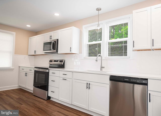 803 Essex Ave, Essex, MD 21221 - kitchen with stainless steel appliances, a sink, dark wood-style floors, white cabinets, and light countertops
