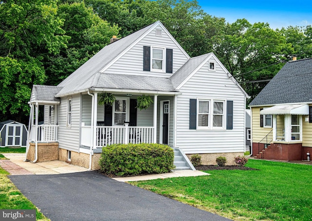 803 Essex Ave, Essex, MD 21221 - bungalow featuring covered porch, a front yard, and roof with shingles