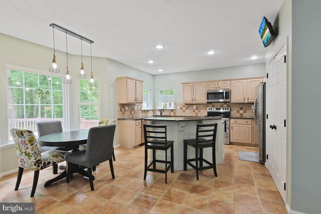 310 Owings Hill Ct, Owings, MD 20736 - kitchen with stainless steel appliances, light brown cabinets, backsplash, dark countertops, and recessed lighting