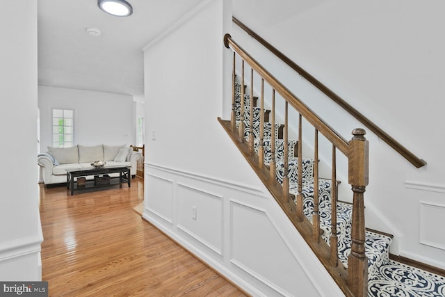 310 Owings Hill Ct, Owings, MD 20736 - stairway with wood finished floors, a wainscoted wall, and a decorative wall