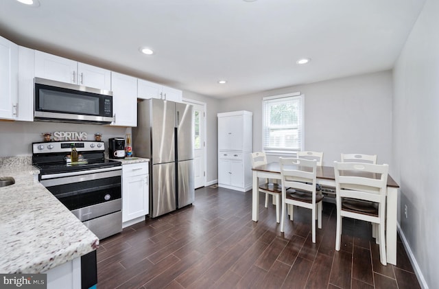 13713 Mayfair Ct, Woodbridge, VA 22193 - kitchen with appliances with stainless steel finishes, white cabinets, dark wood-type flooring, and recessed lighting