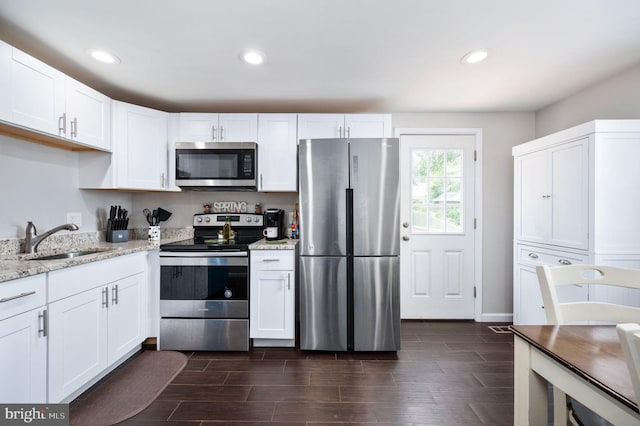 13713 Mayfair Ct, Woodbridge, VA 22193 - kitchen with stainless steel appliances, light stone counters, white cabinets, recessed lighting, and wood finish floors