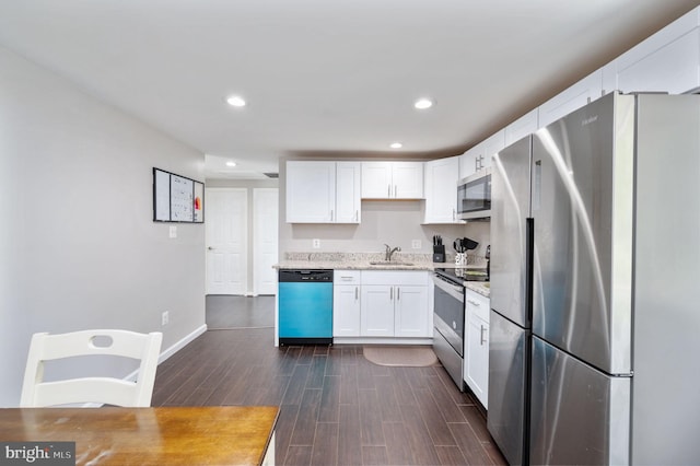 13713 Mayfair Ct, Woodbridge, VA 22193 - kitchen featuring stainless steel appliances, white cabinetry, dark wood-style flooring, recessed lighting, and light stone counters