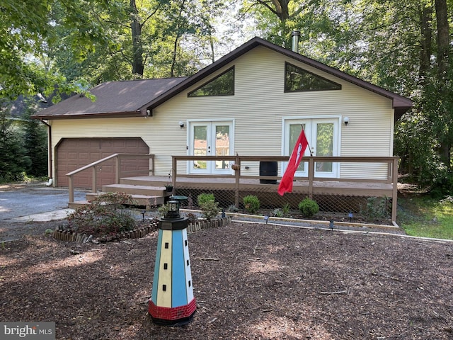 21 Moby Dick Dr, Ocean Pines, MD 21811 - view of front of house with a wooden deck, a garage, asphalt driveway, and french doors