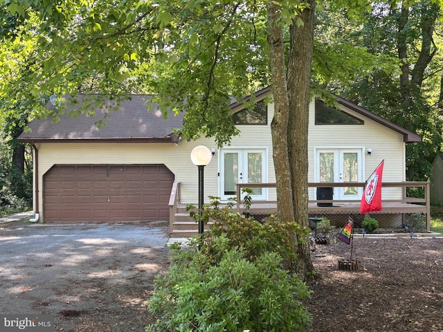 21 Moby Dick Dr, Ocean Pines, MD 21811 - view of front of property featuring french doors, an attached garage, driveway, and a wooden deck