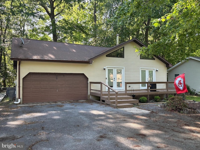 21 Moby Dick Dr, Ocean Pines, MD 21811 - view of front of home with french doors, an attached garage, asphalt driveway, a deck, and roof with shingles