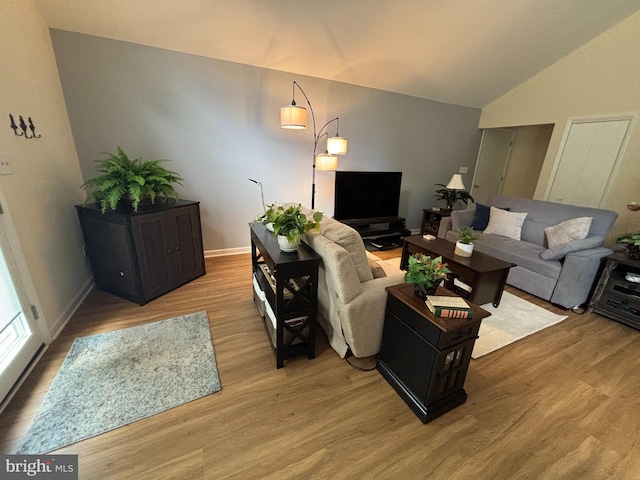21 Moby Dick Dr, Ocean Pines, MD 21811 - living room with light wood finished floors, lofted ceiling, and baseboards