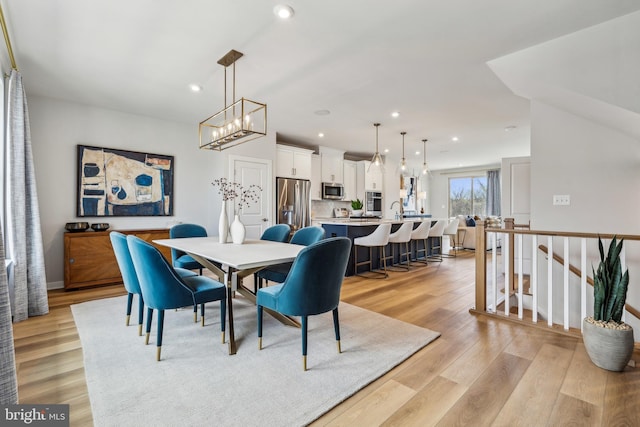 dining room featuring light wood-style floors, recessed lighting, and a chandelier
