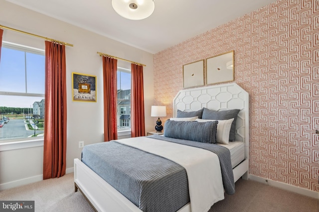 bedroom with wallpapered walls, carpet floors, and baseboards