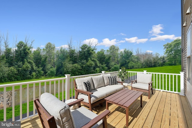 deck with an outdoor living space and a yard