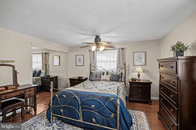 24 Holyoke Dr, Delran, NJ 08075 - bedroom with a textured ceiling, a closet, ceiling fan, and dark wood-style flooring