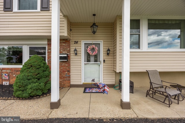 24 Holyoke Dr, Delran, NJ 08075 - doorway to property with brick siding and a porch